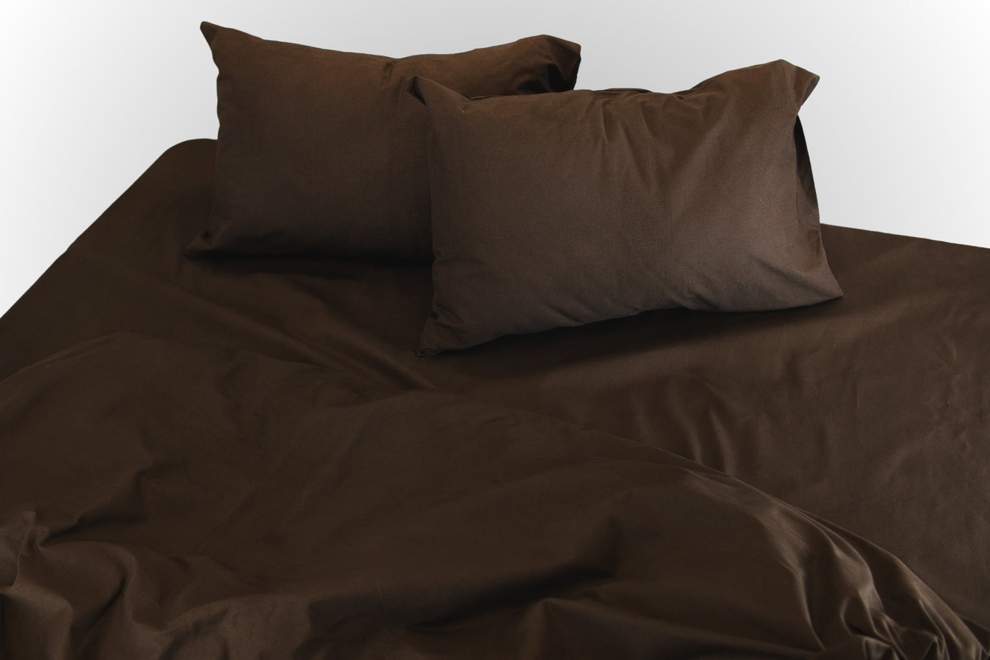 Soft folds of brown ranforce bed linen by Once@Home highlighting breathable cotton fabric