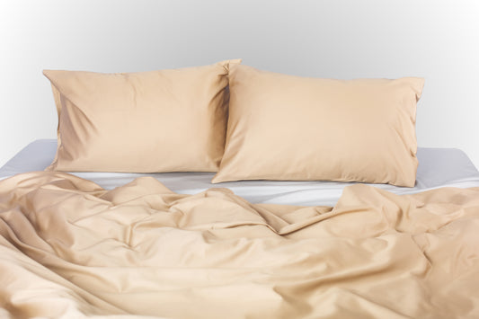 Beige-silver sateen bed linen by Once@Home with soft pillows and a smooth, elegant drape