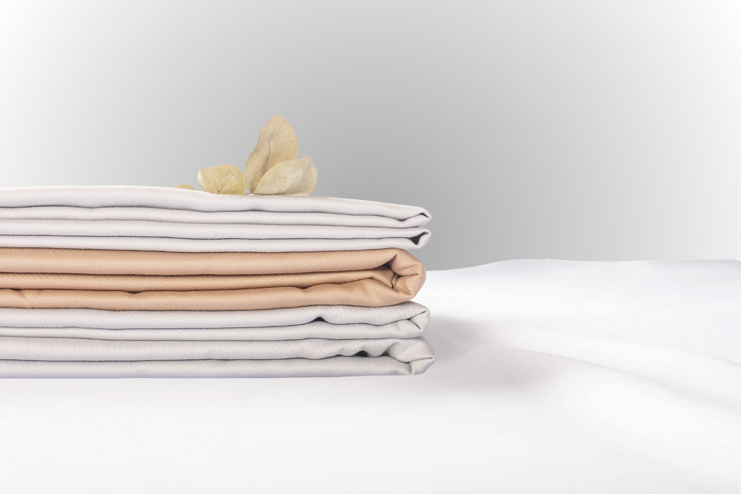 Texture detail of beige-silver sateen bed linen by Once@Home with subtle sheen and soft touch