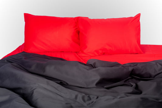 Red and black sateen bed linen by Once@Home with soft pillows and a smooth, elegant drape