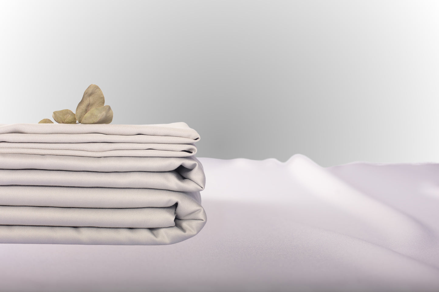 Texture detail of silver sateen bed linen by Once@Home with subtle sheen and soft touch