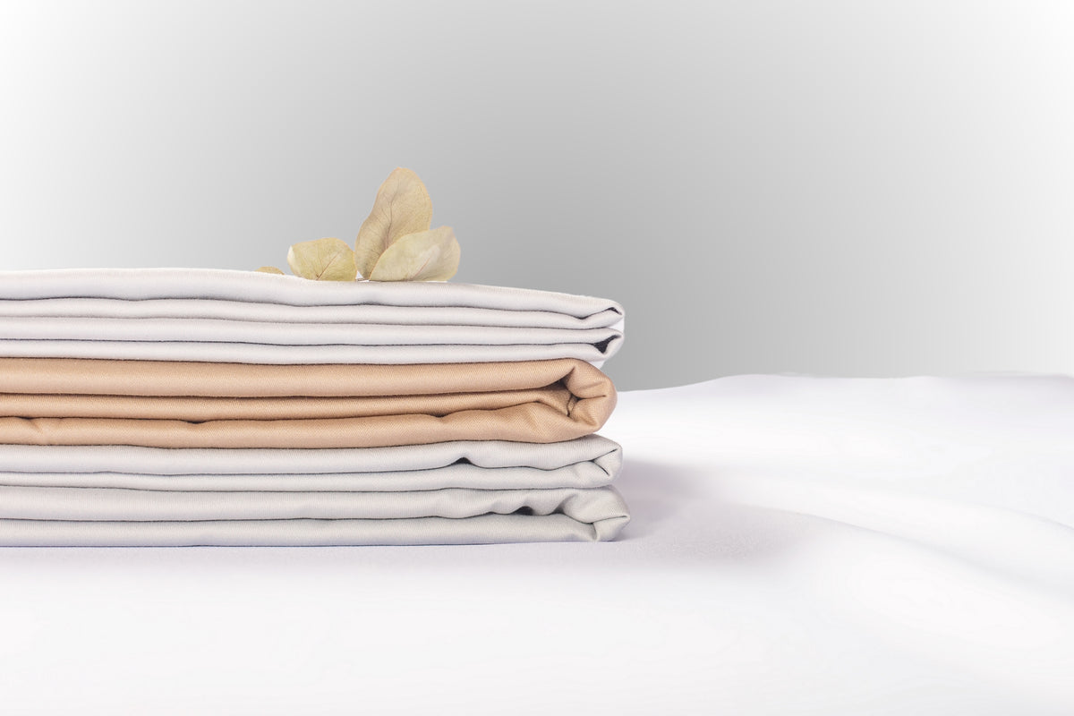 Texture detail of beige-silver sateen bed linen by Once@Home with subtle sheen and soft touch