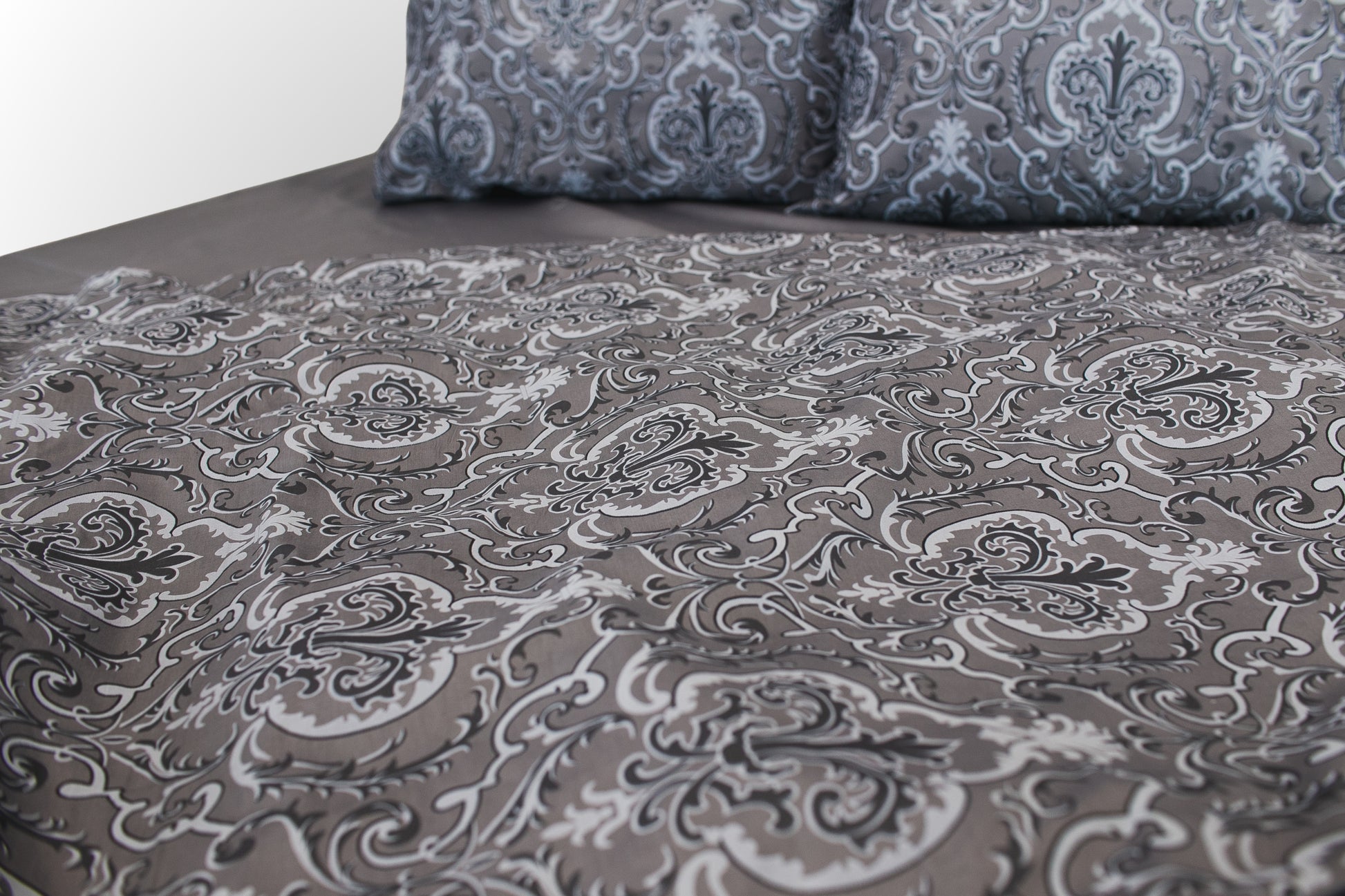 Detail of grey floral sateen bed linen  by Once@Home showing refined print and smooth weave