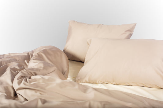 Styled beige-cream sateen bed linen by Once@Home creating a calm and cozy bedroom mood