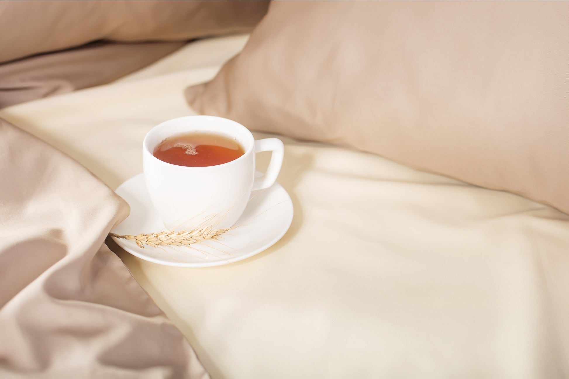 Close-up of beige-cream sateen bed linen by Once@Home highlighting gentle folds and refined finish