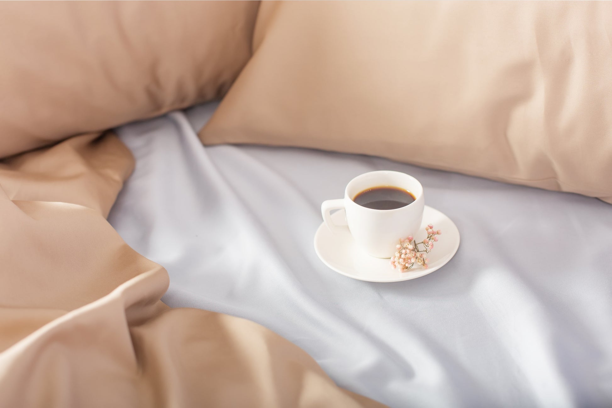 Close-up of beige-silver sateen bed linen by Once@Home showing gentle folds and refined finish