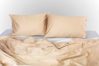 Beige-silver sateen bed linen by Once@Home with soft pillows and a smooth, elegant drape