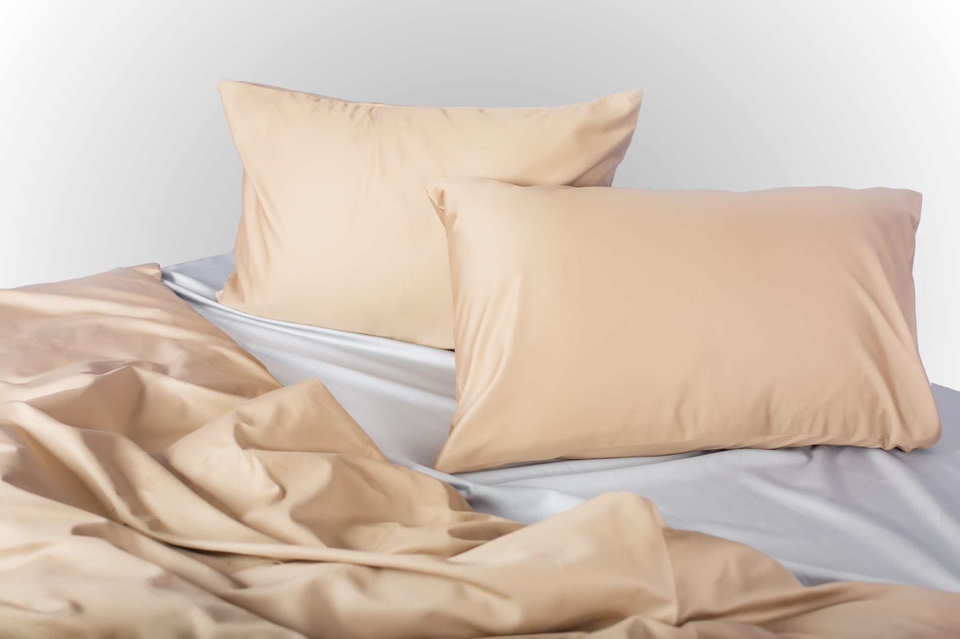 Styled beige-silver sateen bed linen by Once@Home creating a calm and contemporary bedroom atmosphere