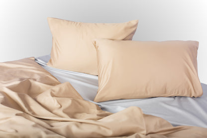 Styled beige-silver sateen bed linen by Once@Home creating a calm and contemporary bedroom atmosphere