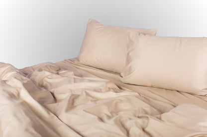 Styled beige sateen bed linen by Once@Home creating a calm, cozy bedroom atmosphere