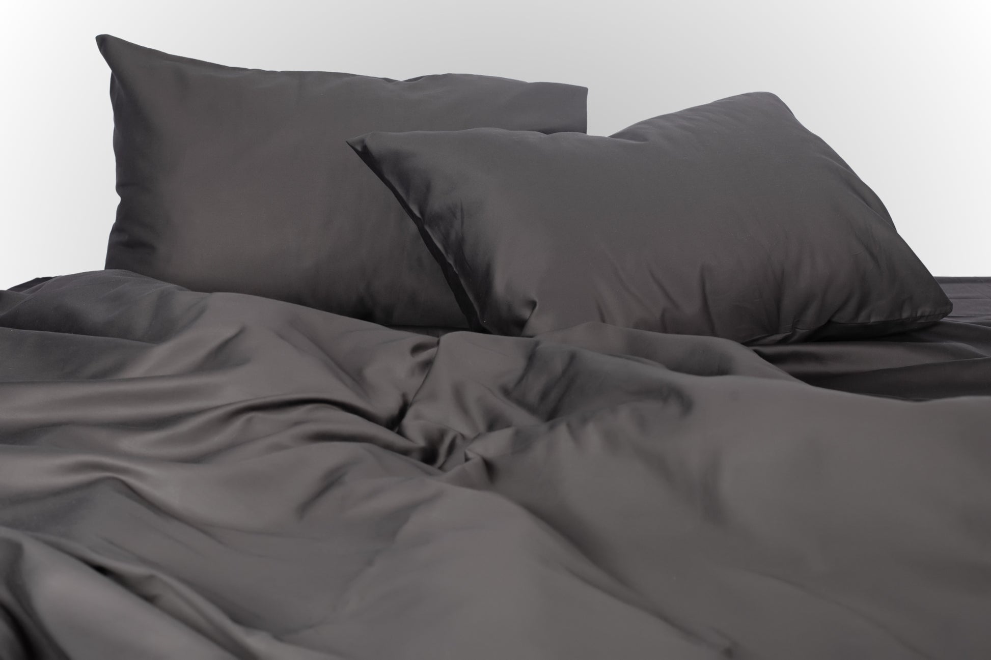 Styled black sateen bed linen by Once@Home creating a refined and sophisticated bedroom atmosphere