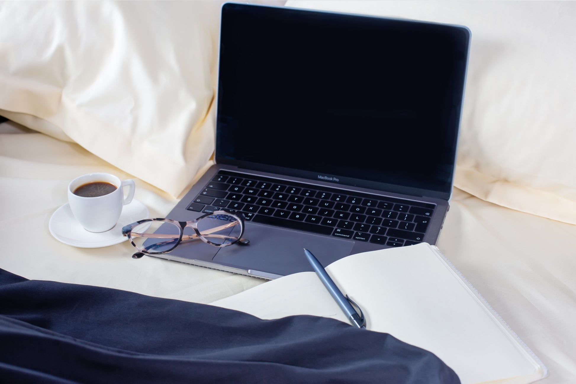Close-up of cream and black sateen bed linen by Once@Home showing gentle folds and refined finish