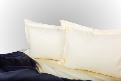 Styled cream and black sateen bed linen by Once@Home creating a calm and sophisticated bedroom atmosphere