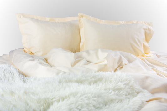 Cream sateen bed linen by Once@Home with soft pillows and a smooth, elegant drape