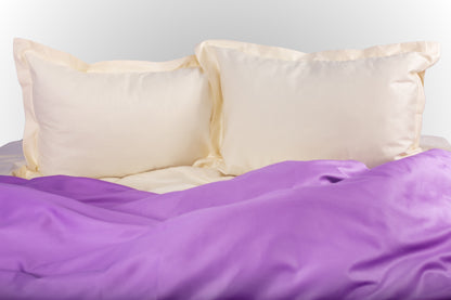 Cream and purple sateen bed linen by Once@Home with soft pillows and a smooth, elegant drape