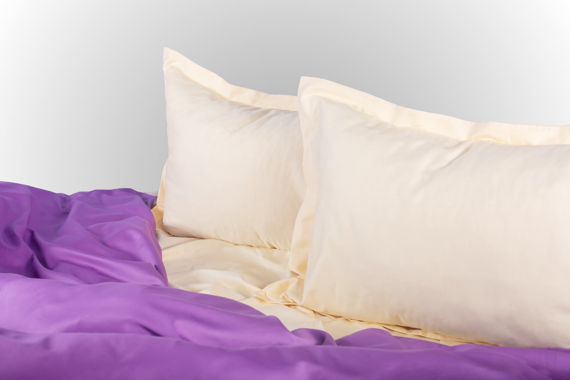 Styled cream and purple sateen bed linen by Once@Home creating a calm and softly expressive bedroom atmosphere