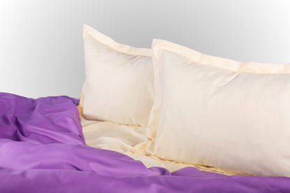 Styled cream and purple sateen bed linen by Once@Home creating a calm and softly expressive bedroom atmosphere