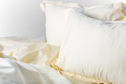 Styled cream sateen bed linen by Once@Home creating a calm and inviting bedroom atmosphere