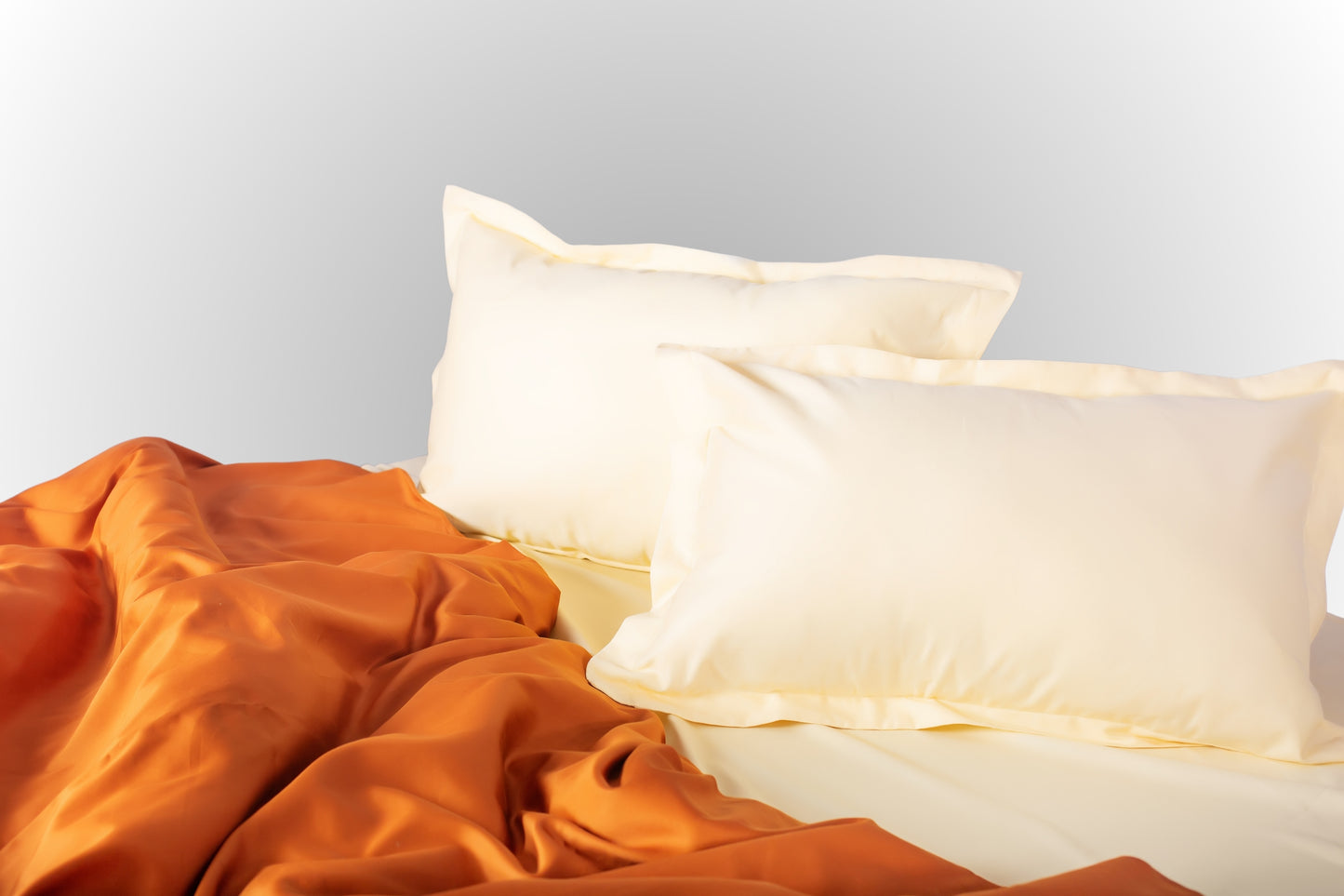 Styled cream-terracotta sateen bed linen by Once@Home creating a warm and calming bedroom atmosphere