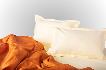 Styled cream-terracotta sateen bed linen by Once@Home creating a warm and calming bedroom atmosphere