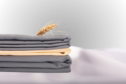 Texture detail of grey and cream sateen bed linen by Once@Home with subtle sheen and soft touch