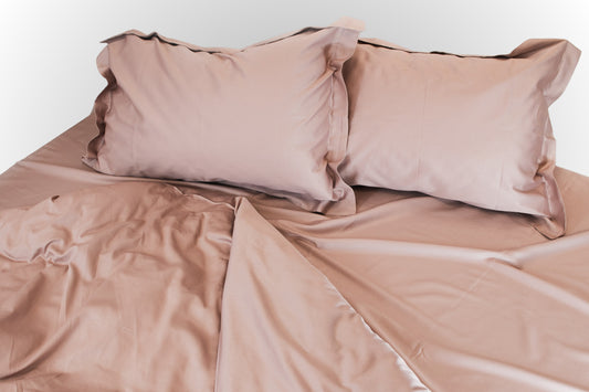 Pale pink sateen bed linen by Once@Home with silky smooth finish and soft drape
