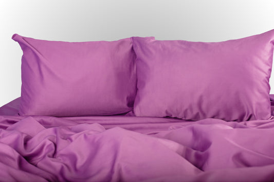 Purple sateen bed linen by Once@Home with soft pillows and a smooth, elegant drape