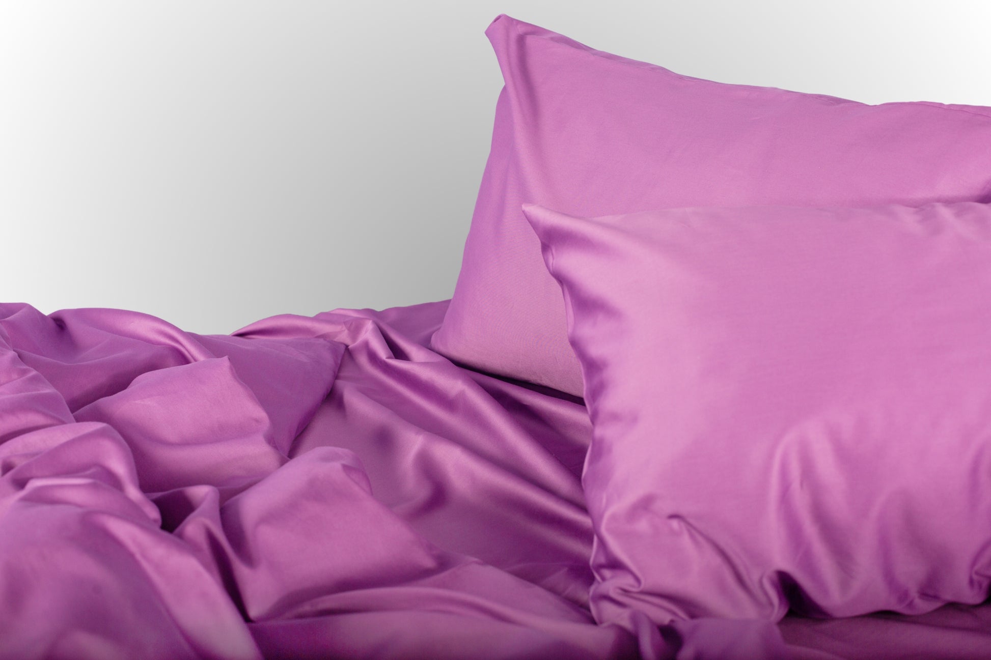 Styled purple sateen bed linen by Once@Home creating a calm and softly expressive bedroom atmosphere
