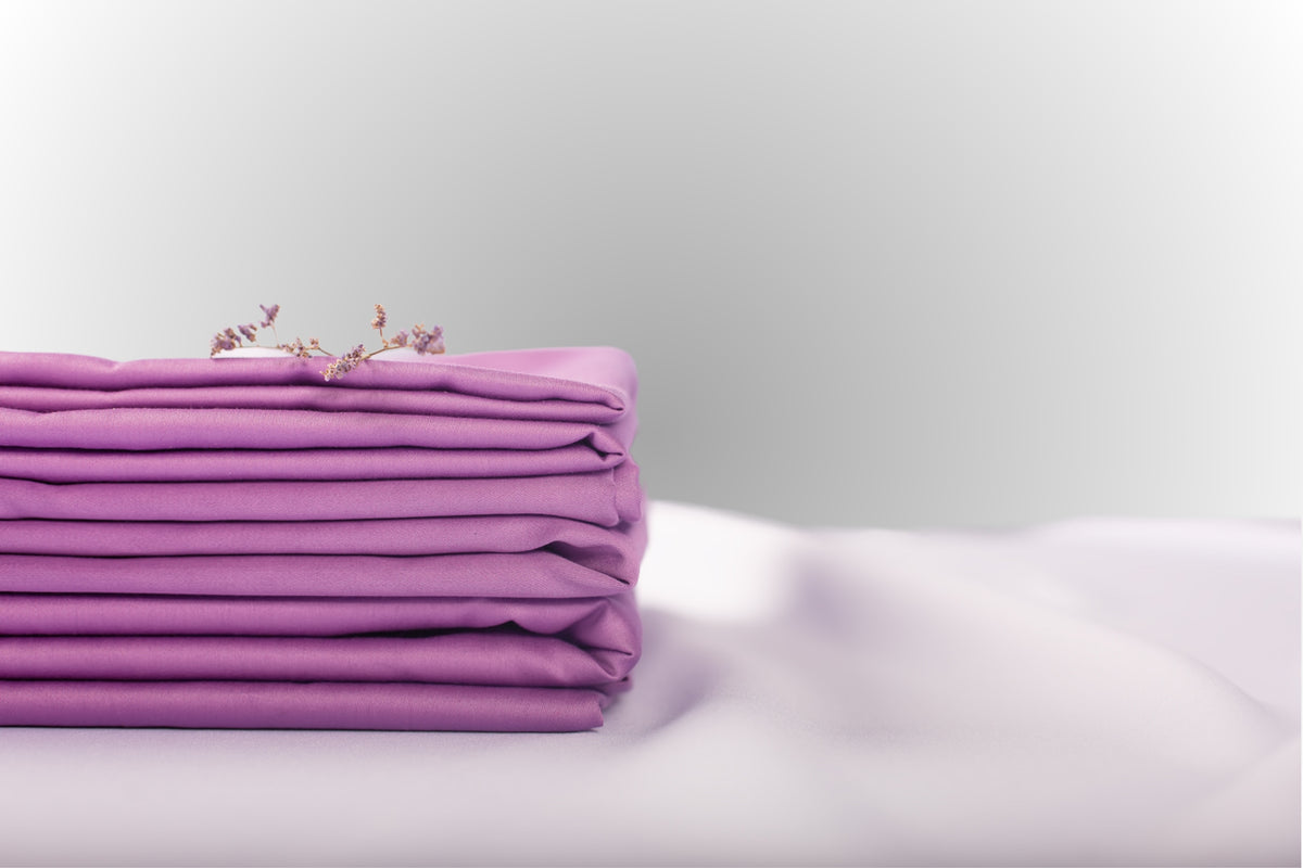 Texture detail of purple sateen bed linen by Once@Home with subtle sheen and soft touch
