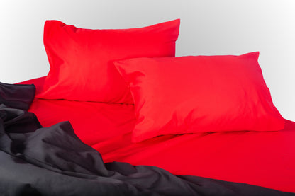 Styled red and black sateen bed linen by Once@Home creating a bold and refined bedroom mood