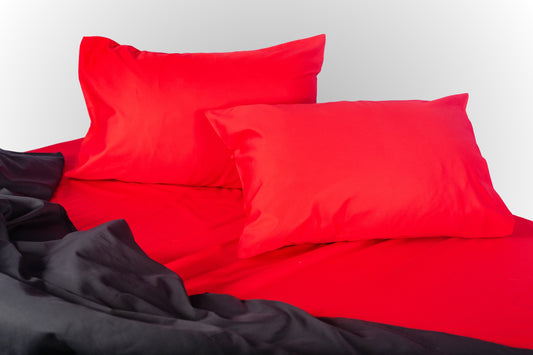 Styled red and black sateen bed linen by Once@Home creating a bold and refined bedroom mood