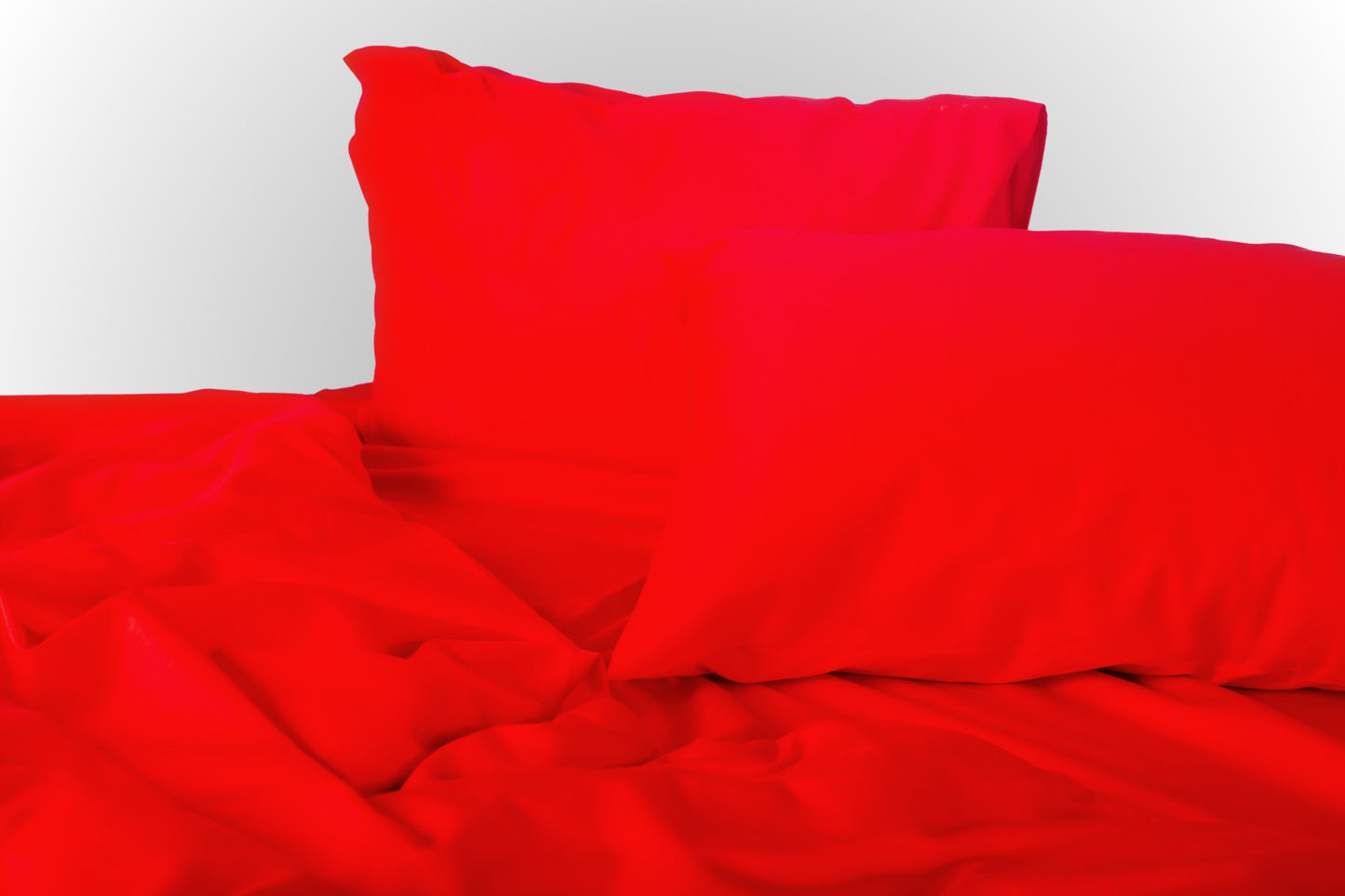 Styled red sateen bed linen by Once@Home creating a warm and expressive bedroom atmosphere