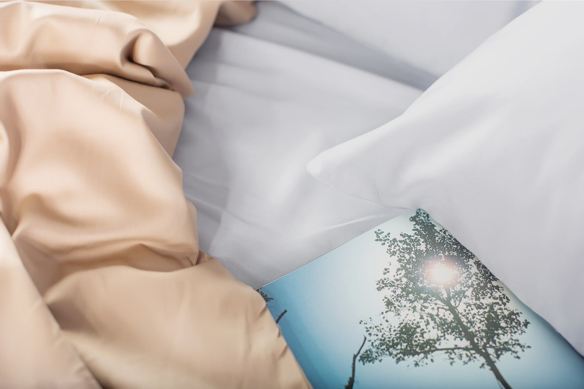 Close-up of silver-beige sateen bed linen by Once@Home highlighting gentle folds and refined finish