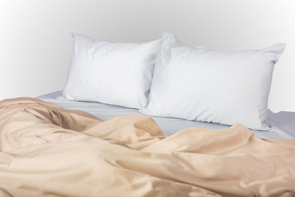 Styled silver-beige sateen bed linen by Once@Home creating a calm and modern bedroom atmosphere