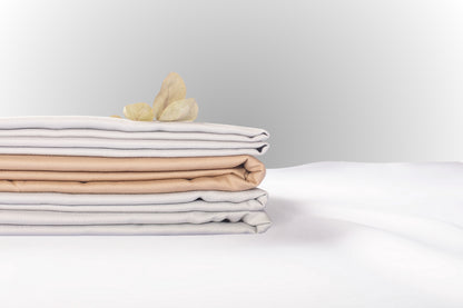 Texture detail of silver and beige sateen bed linen by Once@Home with subtle sheen and soft touch