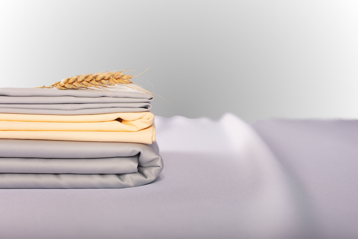 Texture detail of silver and cream sateen bed linen by Once@Home with subtle sheen and soft touch