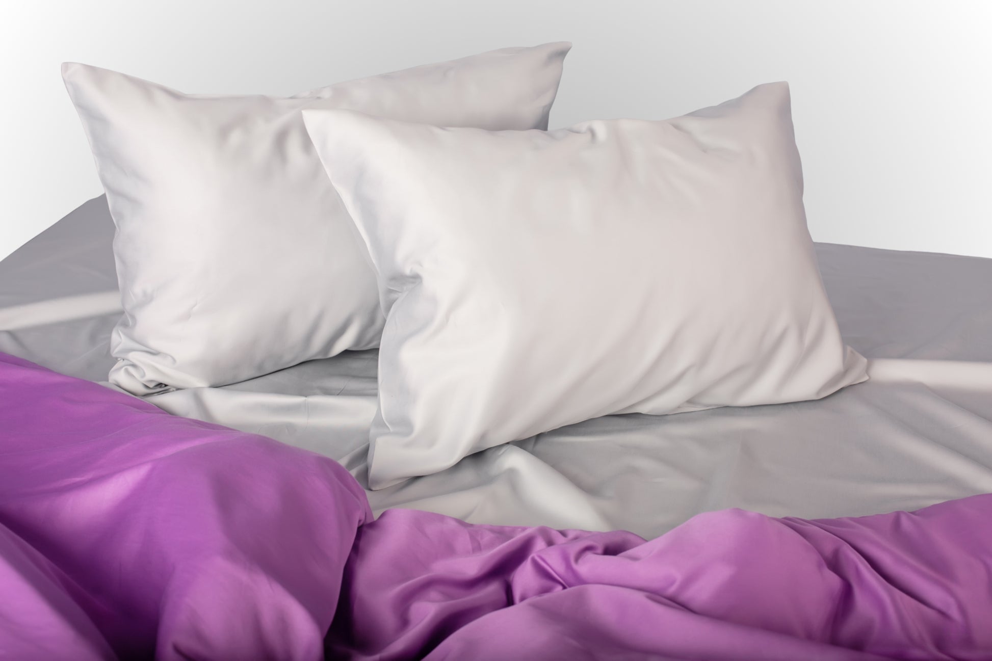 Styled silver and purple sateen bed linen by Once@Home creating a calm and softly expressive bedroom atmosphere