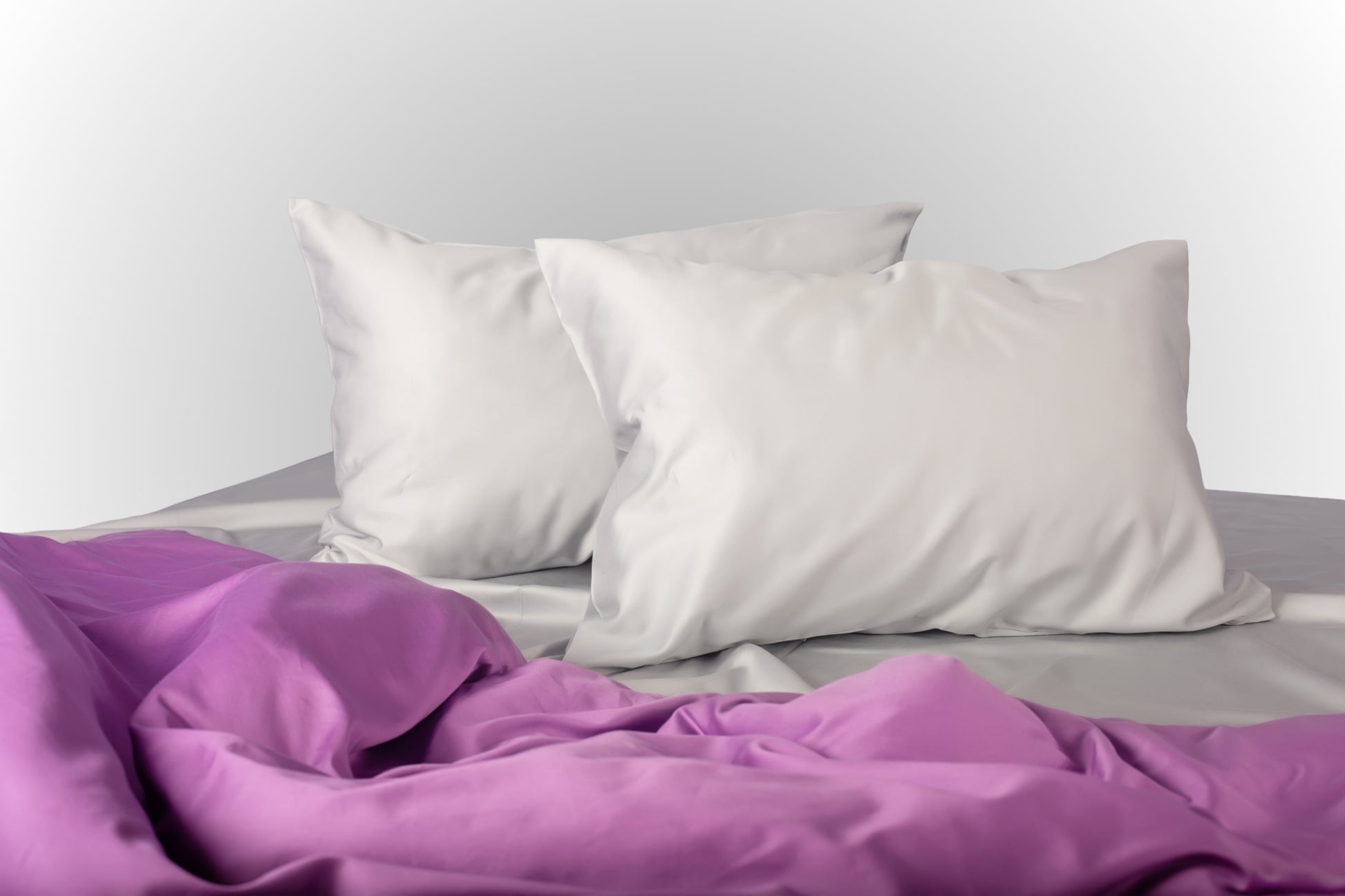 Silver and purple sateen bed linen by Once@Home with soft pillows and a smooth, elegant drape