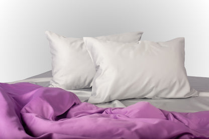 Silver and purple sateen bed linen by Once@Home with soft pillows and a smooth, elegant drape