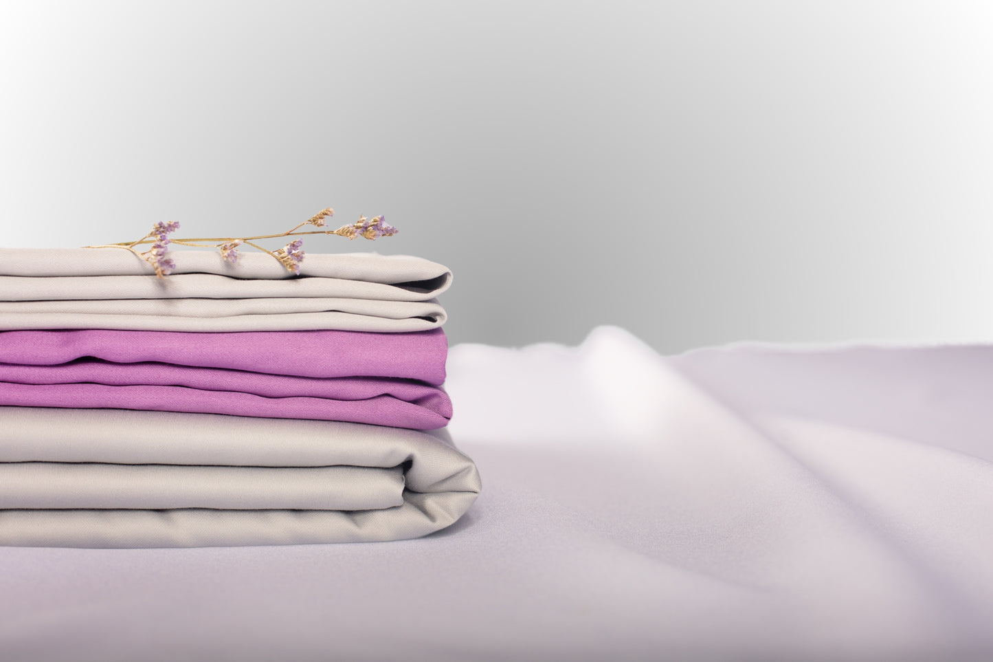 Texture detail of silver and purple sateen bed linen by Once@Home with subtle sheen and soft touch