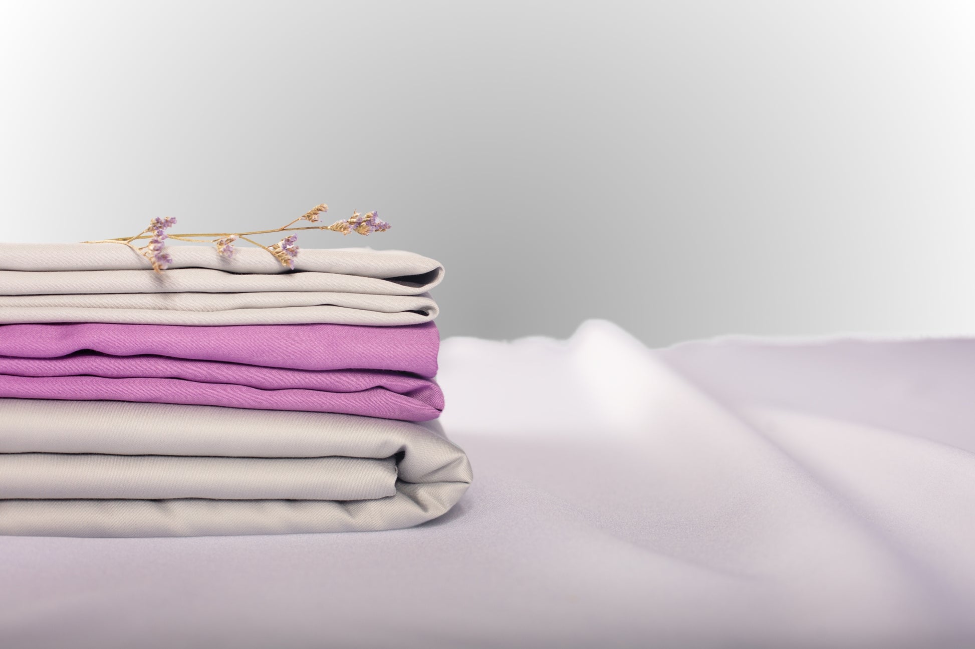 Texture detail of silver and purple sateen bed linen by Once@Home with subtle sheen and soft touch