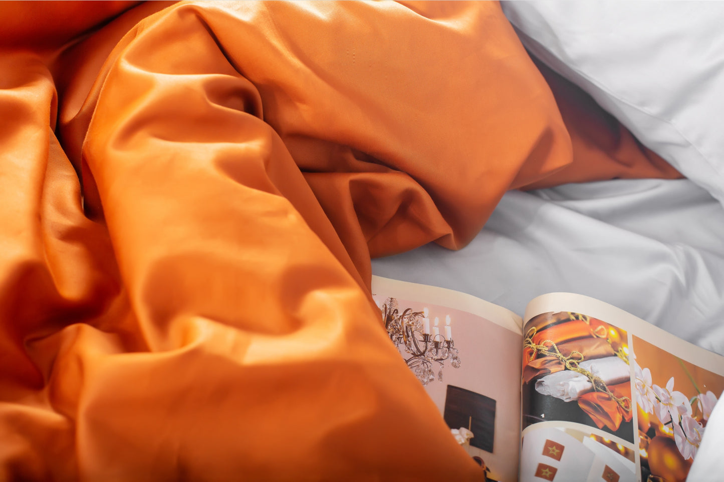 Close-up of silver and terracotta sateen bed linen by Once@Home showing gentle folds and refined finish