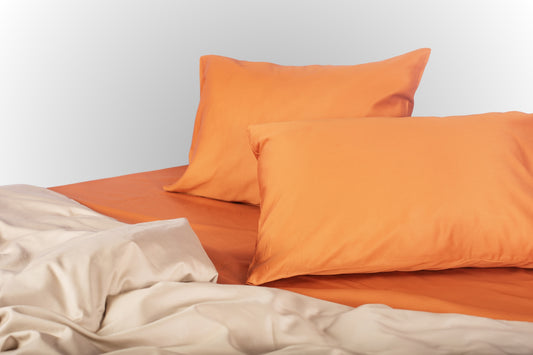 Styled terracotta-beige sateen bed linen by Once@Home creating a warm and calming bedroom atmosphere