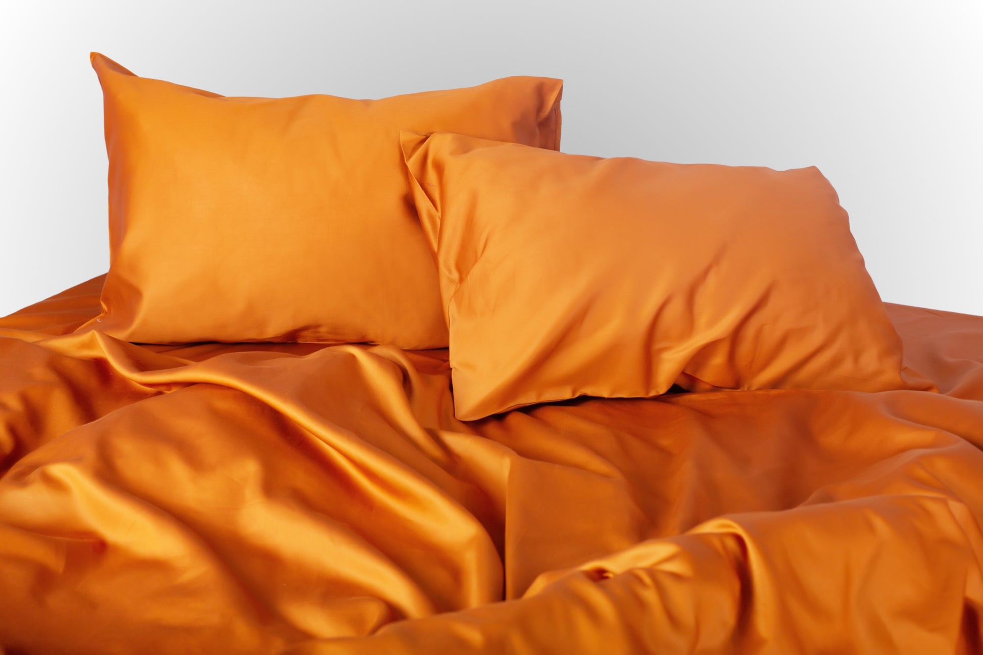 Styled terracotta sateen bed linen by Once@Home creating a warm and inviting bedroom atmosphere