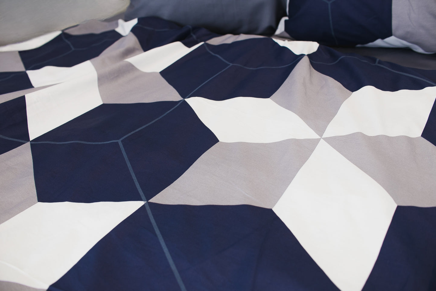 Fabric texture of sateen bed linen by Once@Home with refined geometric pattern