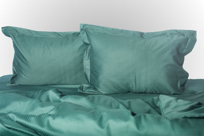 Emerald stripe sateen bed linen by Once@Home with soft pillows and a smooth, elegant drape