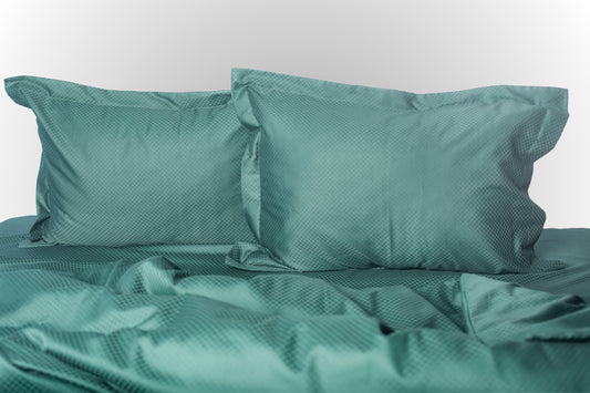 Emerald stripe sateen bed linen by Once@Home with soft pillows and a smooth, elegant drape
