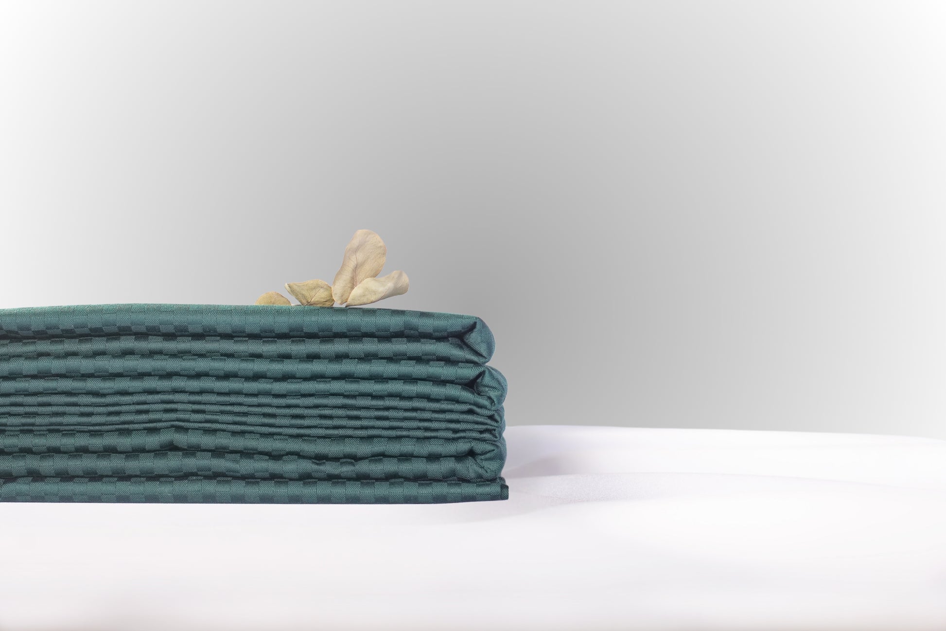 Texture detail of emerald stripe sateen bed linen by Once@Home with delicate stripes and a soft satin sheen